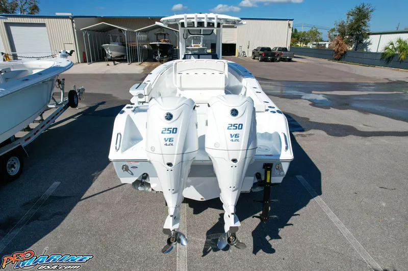 Slide: The Image of 2025 Sea Hunt Gamefish 27 with Coffin Box, featuring dual 250 V6 engines, parked outdoors. - 4