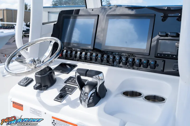 Slide: The Image of 2025 Sea Hunt Gamefish 27 helm with dual screens and controls. - 41