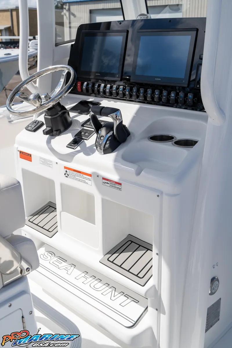 Slide: The Image of 2025 Sea Hunt Gamefish 27 helm with dual screens and controls. - 42
