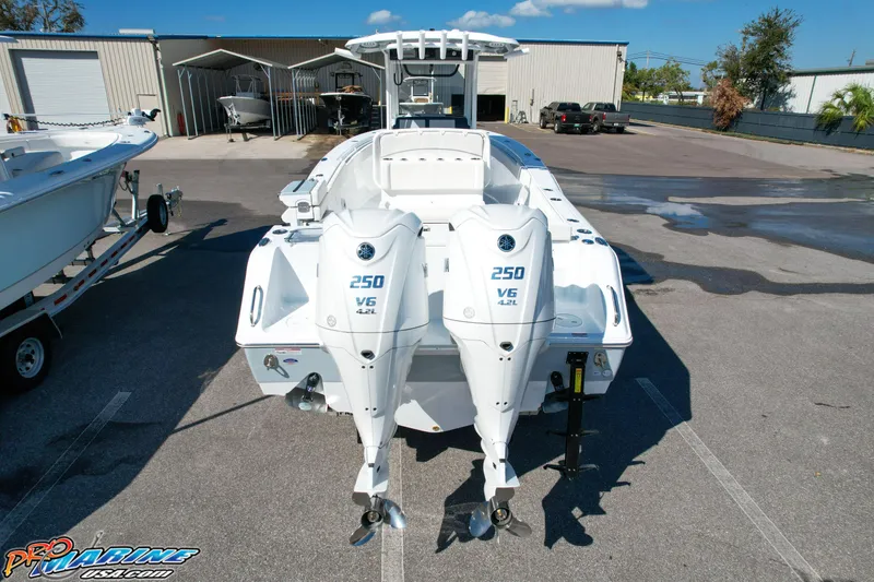 Slide: The Image of 2025 Sea Hunt Gamefish 27 with Coffin Box, dual 250 V6 engines, parked outdoors. - 5