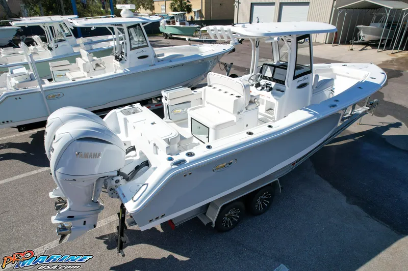 Slide: The Image of 2025 Sea Hunt Gamefish 27 boat with coffin box, dual engines, parked on trailer. - 7