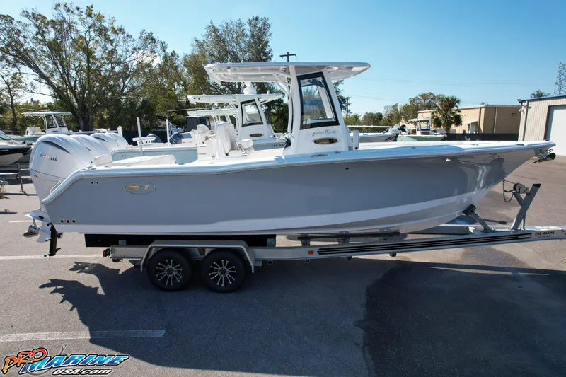 Slide: The Image of 2025 Sea Hunt Gamefish 27 with Coffin Box on trailer, parked outdoors. - 9