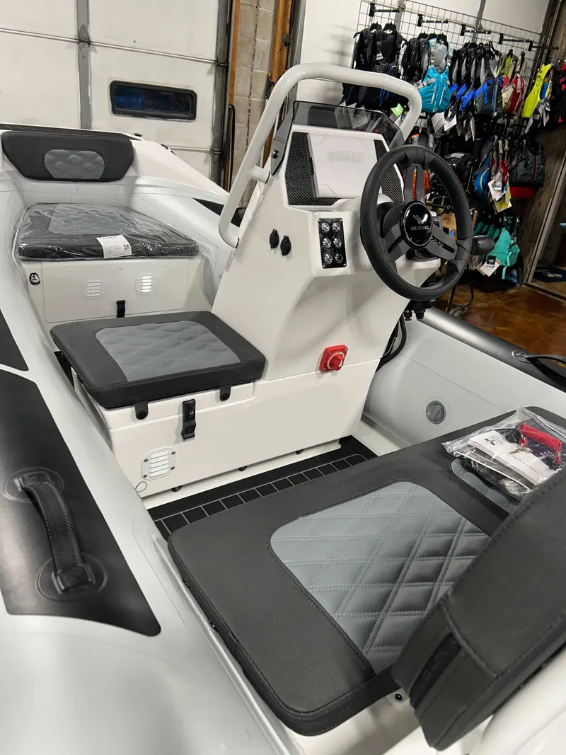 Slide: The Image of 2025 Highfield Sport 360 boat interior with modern seating and steering console. - 3