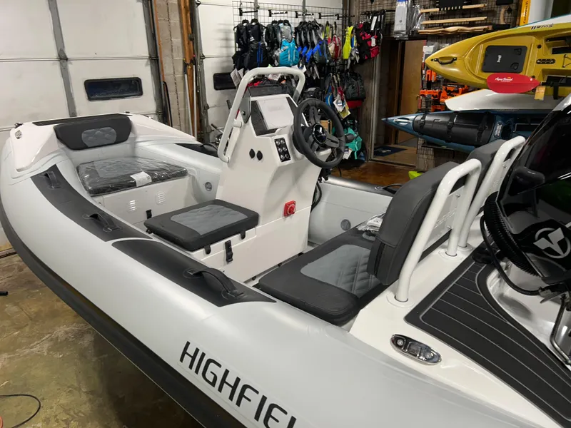 Slide: The Image of 2025 Highfield Sport 360 inflatable boat in showroom, featuring modern design and seating. - 4