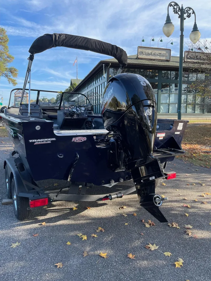 Slide: The Image of 2025 Tracker Targa V-18 WT boat with outboard motor, parked outdoors. - 4