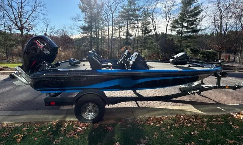 The Image of 2025 Nitro Z18 boat on trailer, parked outdoors near a building. - 0