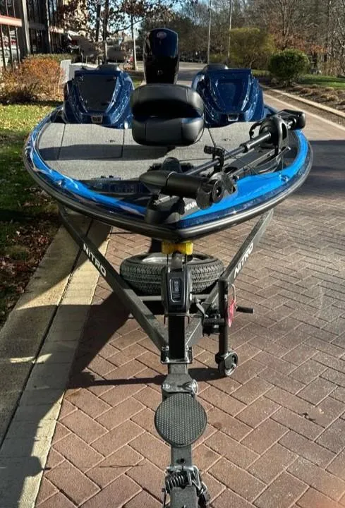 Slide: The Image of 2025 Nitro Z18 boat on trailer, parked on brick pavement. - 2