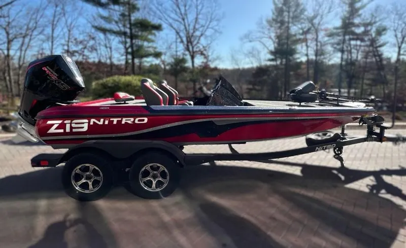 The Image of 2025 Nitro Z19 boat with sleek design, parked on a trailer outside a building. - 0
