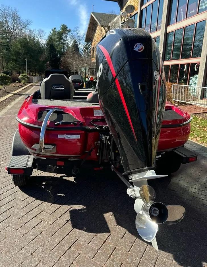 Slide: The Image of 2025 Nitro Z19 boat with powerful outboard motor, parked on brick pavement. - 3