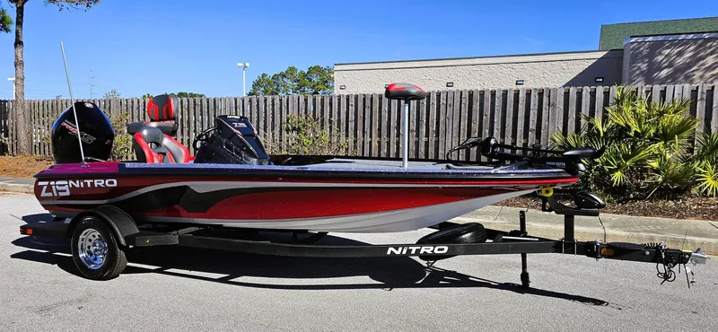 Slide: The Image of 2025 Nitro Z19 boat on trailer, parked outdoors, side view. - 1