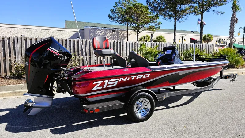 Slide: The Image of 2025 Nitro Z19 boat with sleek red design and powerful engine on a trailer. - 3