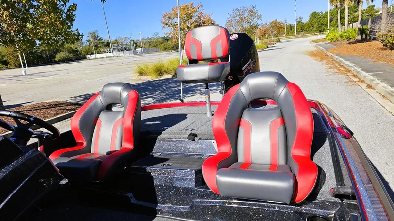 Slide: The Image of 2025 Nitro Z19 boat with red and gray seats in a sunny outdoor setting. - 8