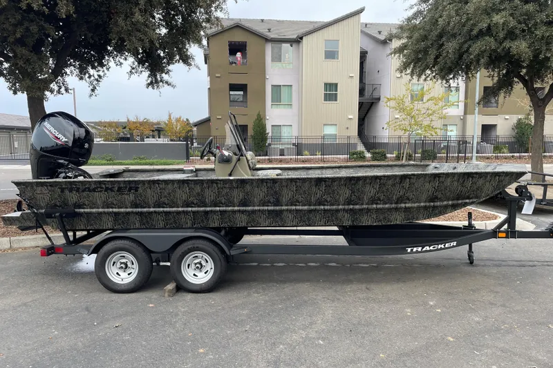 The Image of 2025 Tracker Grizzly 2072 CC boat on trailer, parked in urban setting. - 0