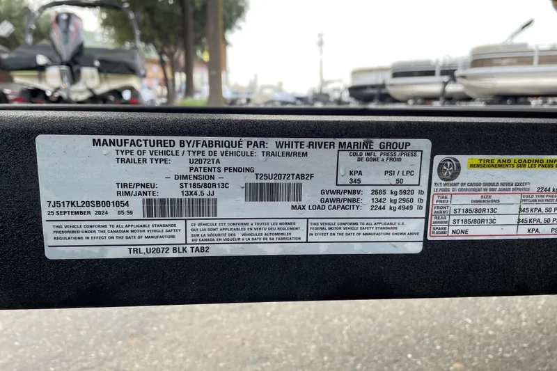Slide: The Image of Label on a 2025 Tracker Grizzly 2072 CC trailer, detailing specifications and compliance information. - 14