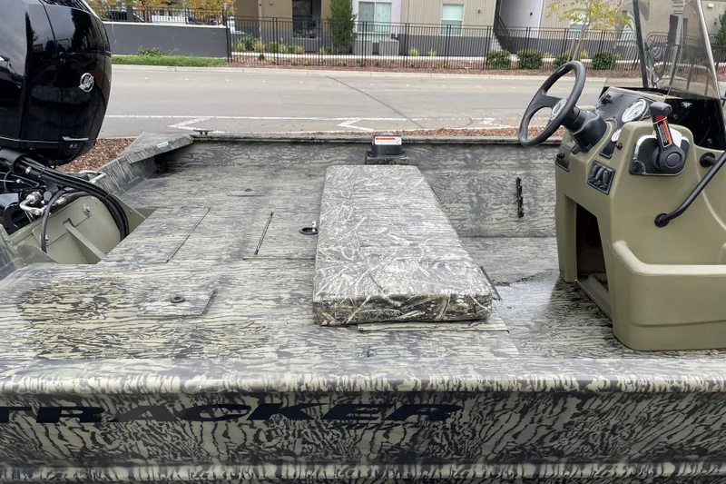 Slide: The Image of 2025 Tracker Grizzly 2072 CC boat interior with camouflage design and steering console. - 7