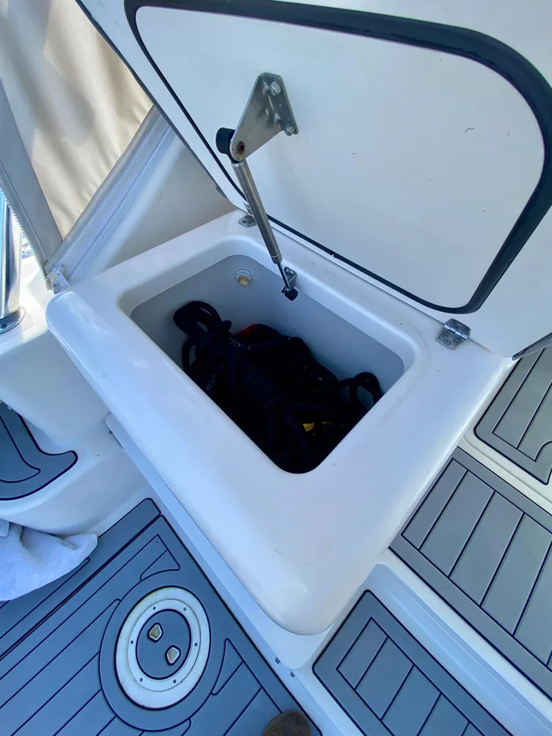 Slide: The Image of Open storage compartment on 2004 Pursuit 3100 Offshore boat deck. - 10