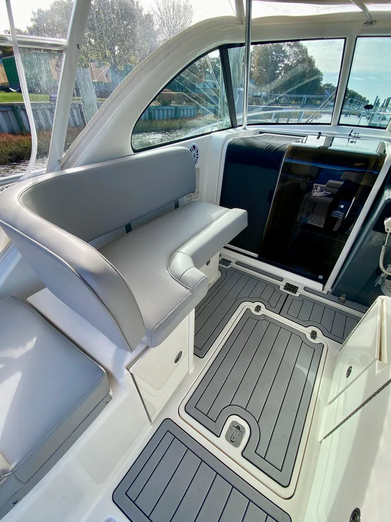 Slide: The Image of 2004 Pursuit 3100 Offshore boat interior with seating and sleek design. - 11