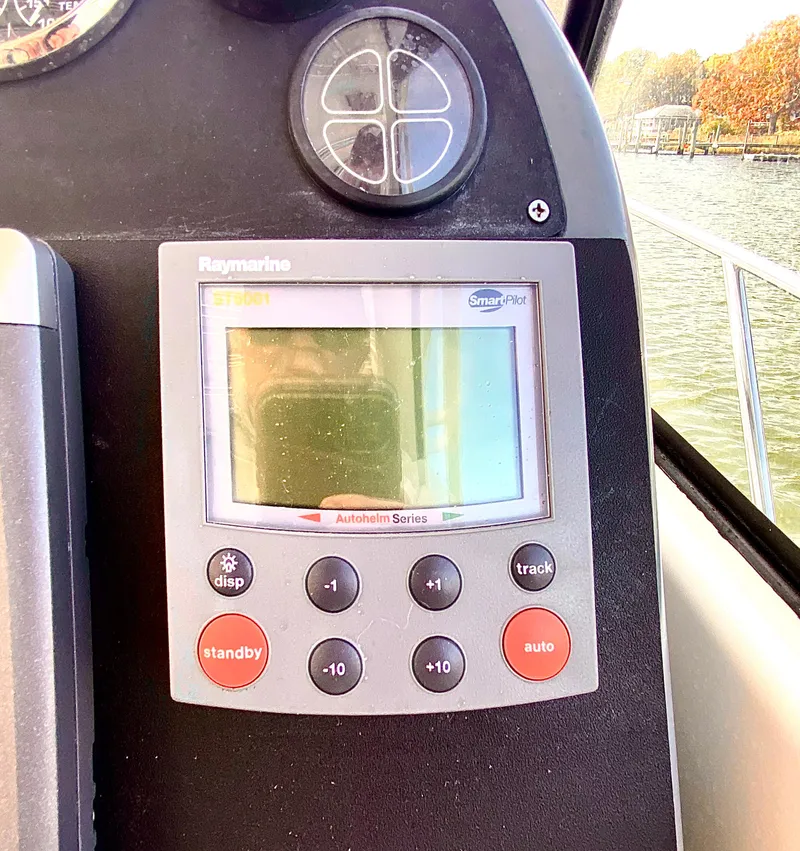 Slide: The Image of Raymarine autopilot display on 2004 Pursuit 3100 Offshore boat dashboard. - 15