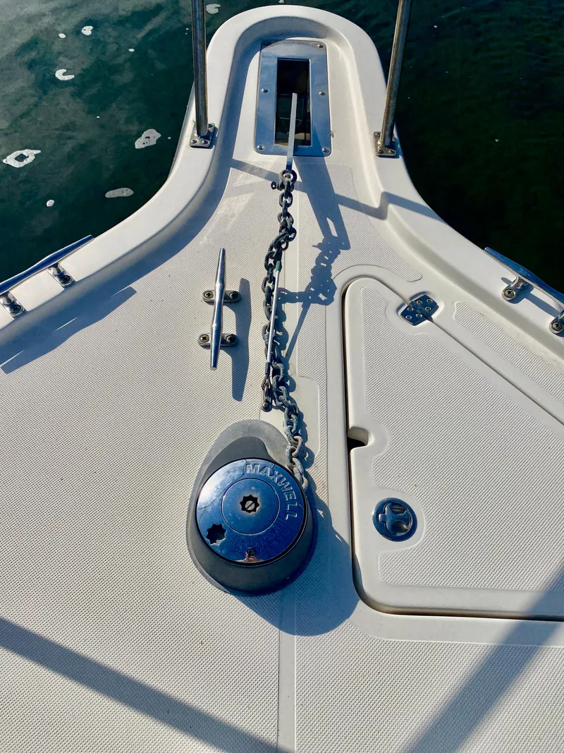 Slide: The Image of 2004 Pursuit 3100 Offshore boat deck with anchor chain and winch. - 2