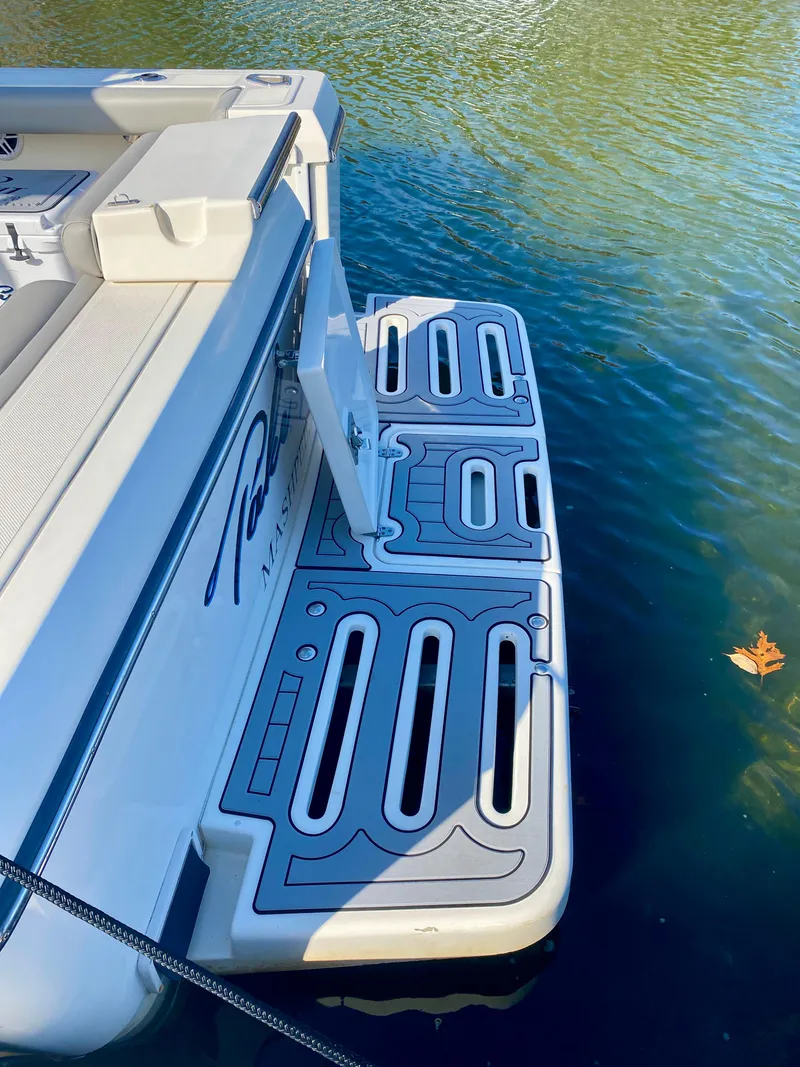 Slide: The Image of 2004 Pursuit 3100 Offshore boat with swim platform on calm water. - 4