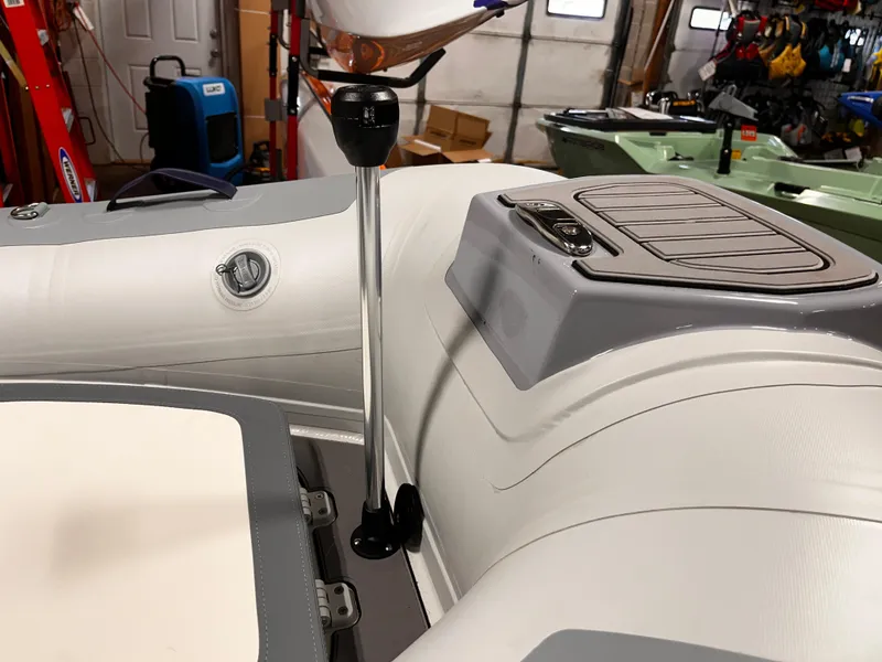Slide: The Image of 2025 Highfield Classic 310 FCT boat interior with steering column in a garage setting. - 17