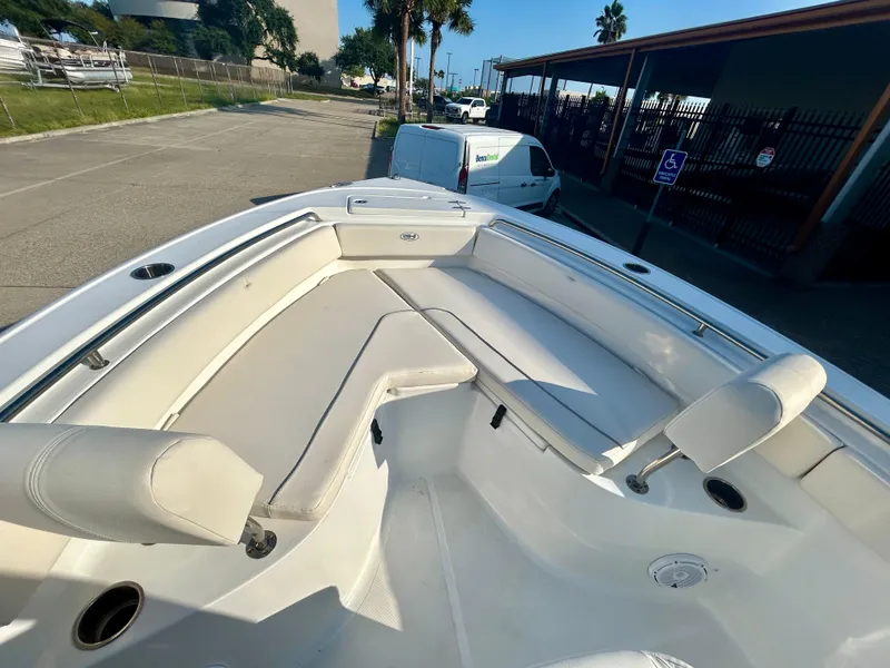 Slide: The Image of 2023 Sea Hunt Ultra 219 boat with spacious seating and sleek design. - 11