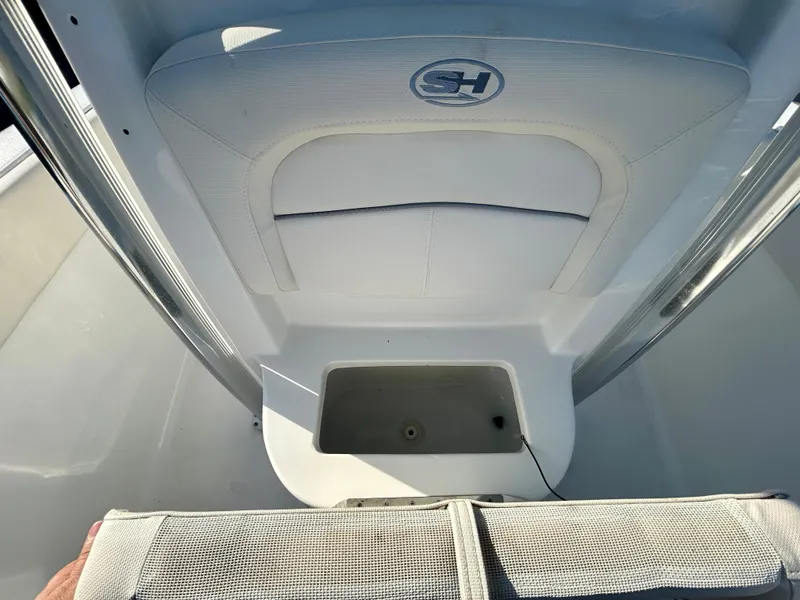 Slide: The Image of 2023 Sea Hunt Ultra 219 boat interior with storage compartment and seating. - 12