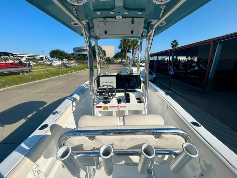 Slide: The Image of 2023 Sea Hunt Ultra 219 boat interior with console and rod holders. - 15