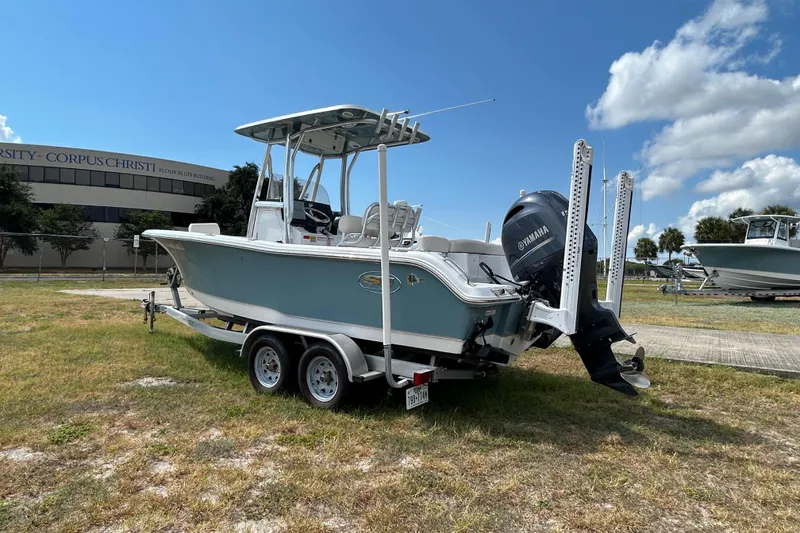 Slide: The Image of 2023 Sea Hunt Ultra 219 boat with Yamaha engine on trailer, parked outdoors. - 3