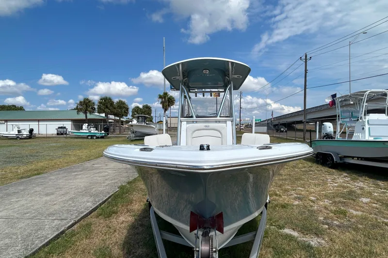Slide: The Image of 2023 Sea Hunt Ultra 219 boat displayed outdoors under a clear blue sky. - 8