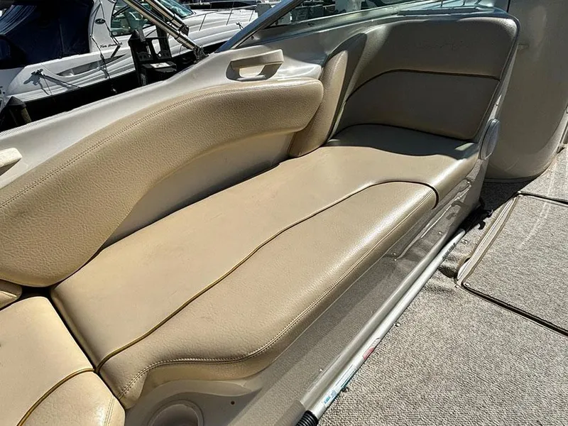 Slide: The Image of Beige seating on 2002 Sea Ray 240 Sundeck boat, showcasing comfortable interior design. - 11