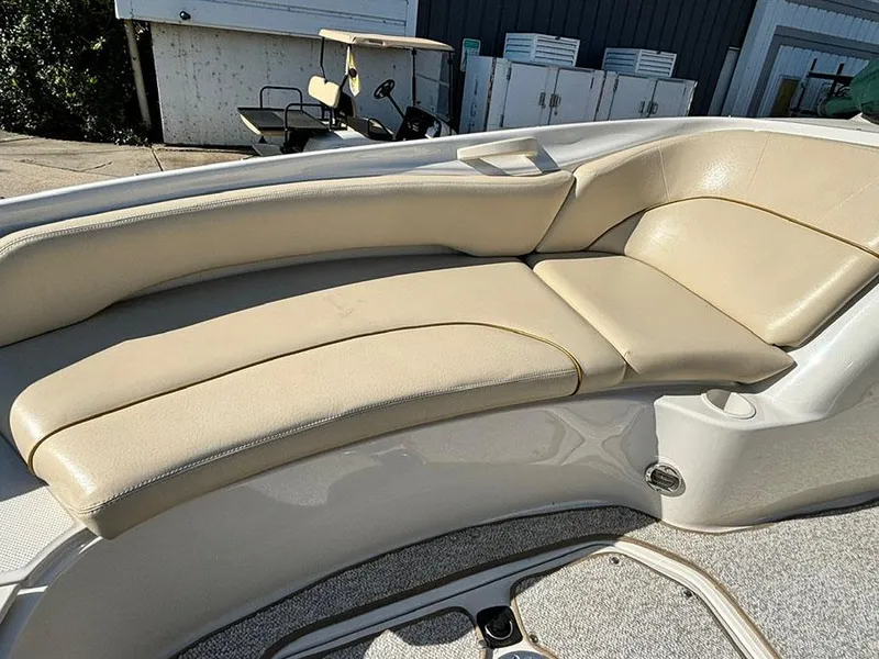 Slide: The Image of 2002 Sea Ray 240 Sundeck beige seating area with sunlit upholstery. - 18
