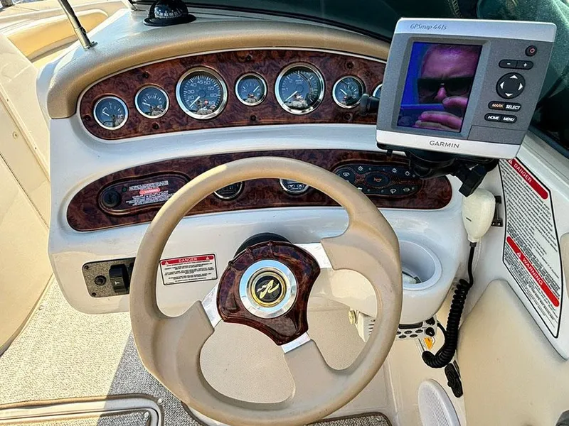 Slide: The Image of 2002 Sea Ray 240 Sundeck dashboard with Garmin GPS and wood grain accents. - 5