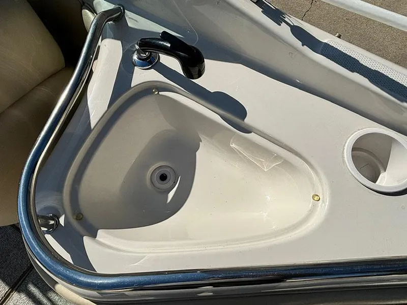 Slide: The Image of 2002 Sea Ray 240 Sundeck sink with faucet and cup holder. - 7