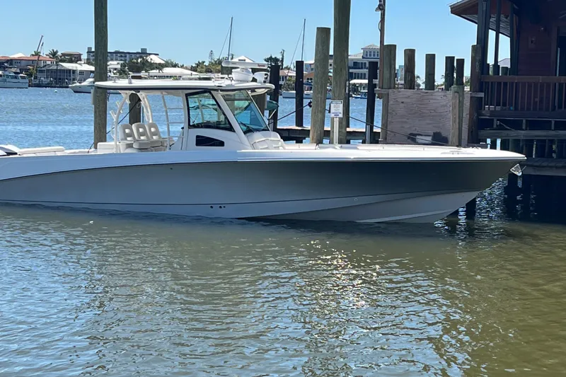 The Image of 2014 Boston Whaler 370 Outrage boat docked in a marina. - 1