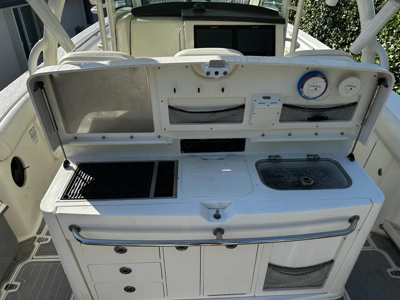 Slide: The Image of Boston Whaler 370 Outrage 2014 boat kitchen area with grill and sink. - 3
