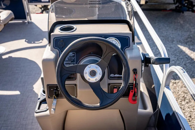 Slide: The Image of 2025 Sun Tracker Bass Buggy 16 DLX steering console with controls and gauges. - 11