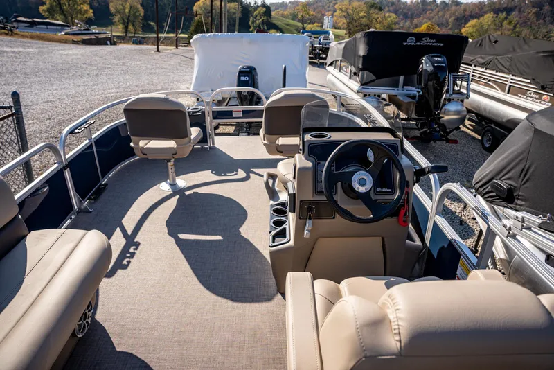 Slide: The Image of 2025 Sun Tracker Bass Buggy 16 DLX pontoon boat interior with steering console and seating. - 13