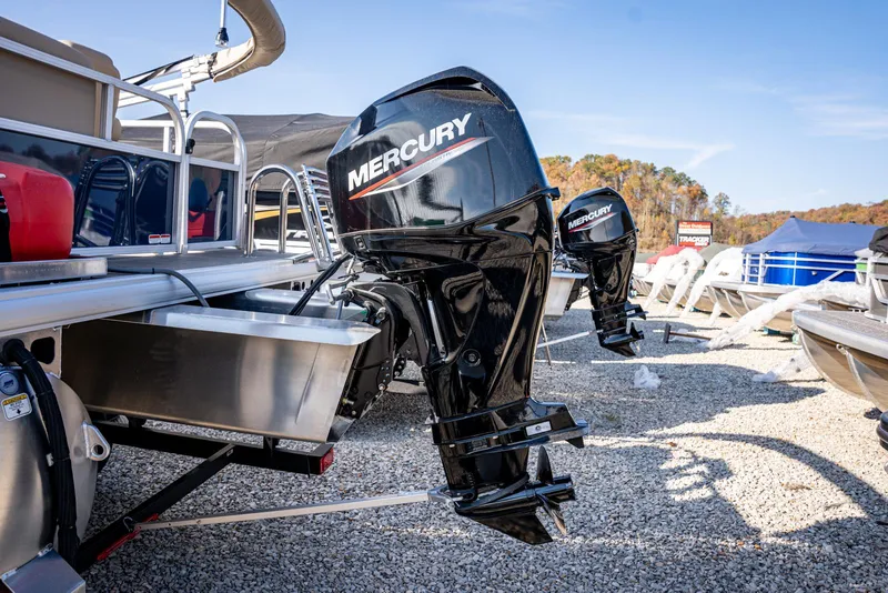 Slide: The Image of 2025 Sun Tracker Bass Buggy 16 DLX with Mercury outboard motor in a marina setting. - 3