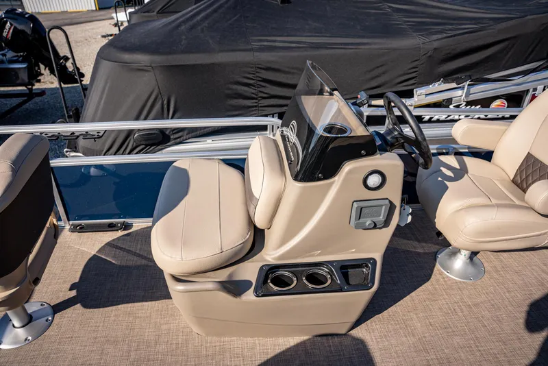 Slide: The Image of 2025 Sun Tracker Bass Buggy 16 DLX boat interior with beige seating and steering console. - 7