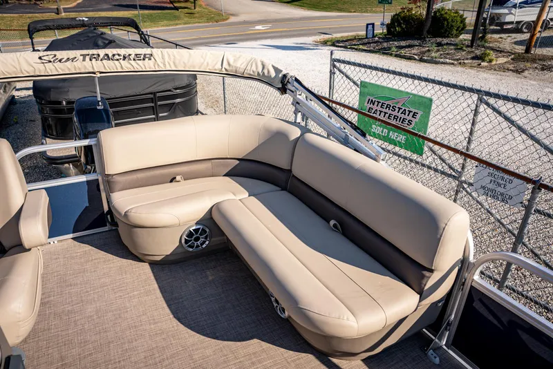 Slide: The Image of 2025 Sun Tracker Bass Buggy 16 DLX pontoon boat with beige seating and spacious deck. - 9