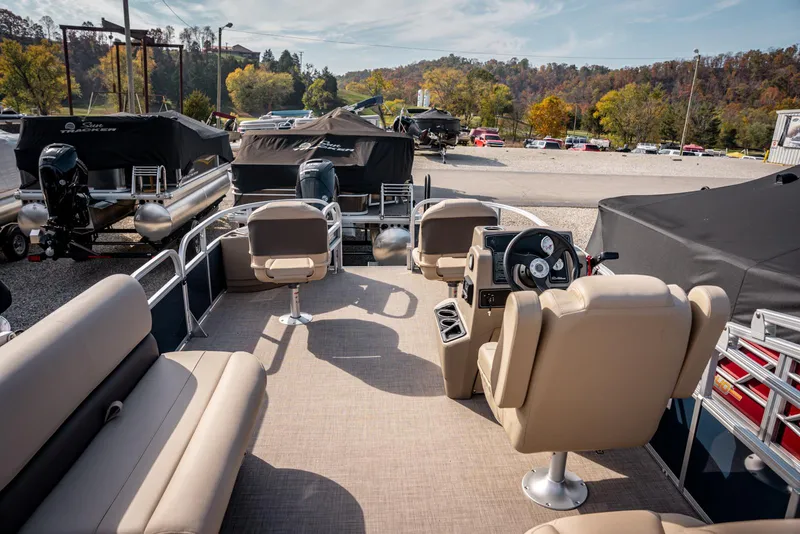 Slide: The Image of 2025 Sun Tracker BASS BUGGY 18 pontoon boat interior with seating and steering console. - 14
