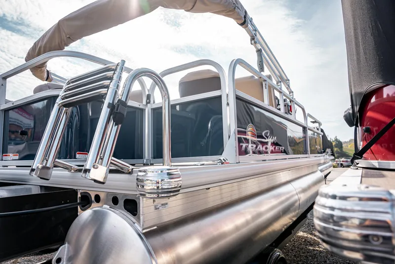 Slide: The Image of 2025 Sun Tracker BASS BUGGY 18 pontoon boat, sleek design, outdoor setting. - 5