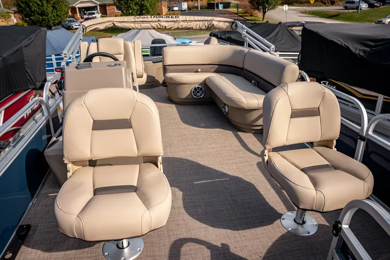 Slide: The Image of 2025 Sun Tracker BASS BUGGY 18 pontoon boat with beige seating and spacious deck. - 6