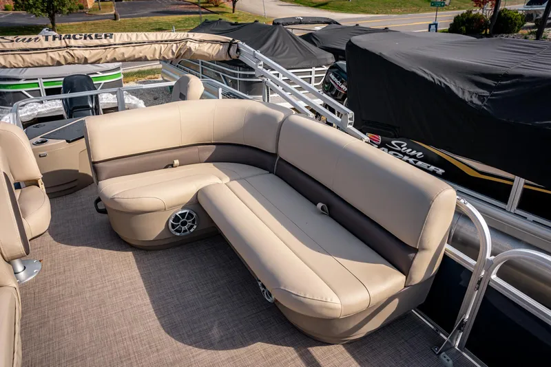 Slide: The Image of 2025 Sun Tracker BASS BUGGY 18 pontoon boat with beige seating and spacious deck. - 9