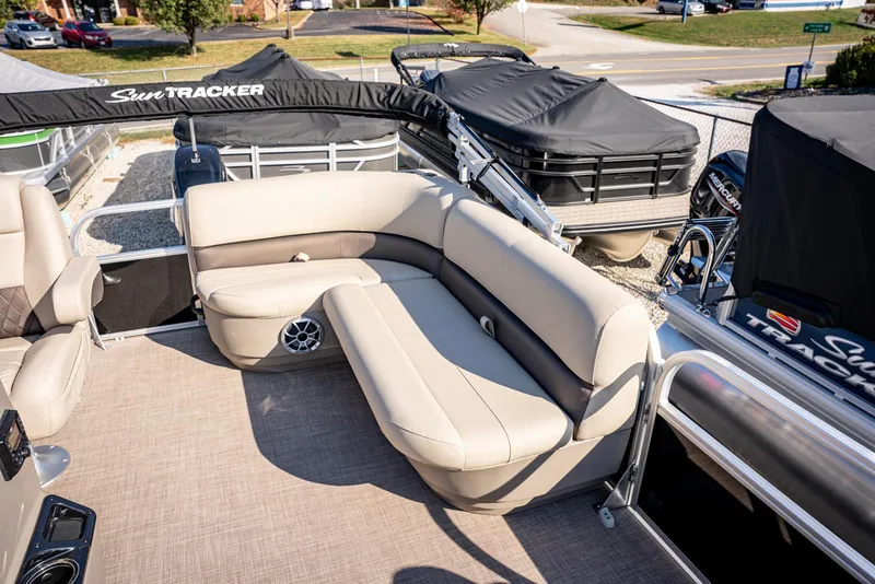 Slide: The Image of 2025 Sun Tracker Party Barge 16 with beige seating and covered motor. - 9