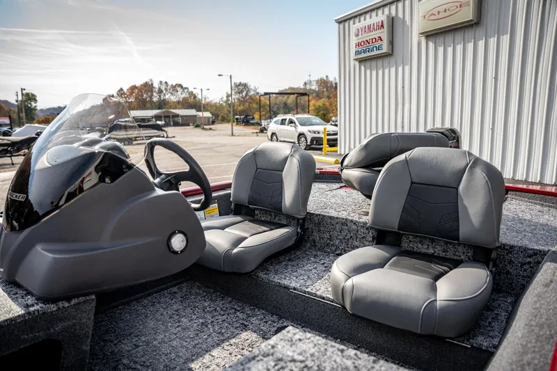 Slide: The Image of 2025 Bass Tracker Pro Team 170 boat interior with gray seating and steering console. - 10