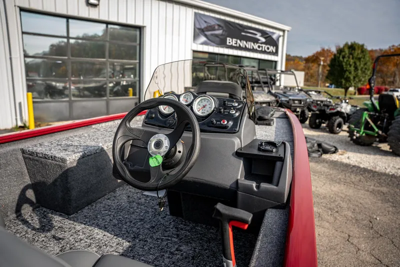 Slide: The Image of 2025 Bass Tracker Pro Team 170 boat interior with steering wheel and dashboard. - 12