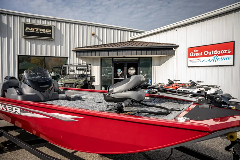 Slide: The Image of 2025 Bass Tracker Pro Team 170 boat displayed outside marine store. - 5