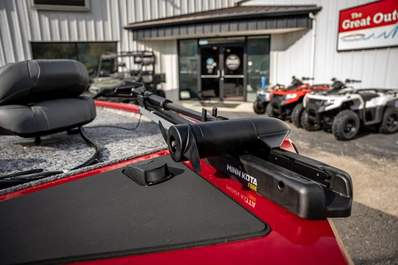 Slide: The Image of 2025 Bass Tracker Pro Team 170 boat with Minn Kota trolling motor, parked outside dealership. - 6